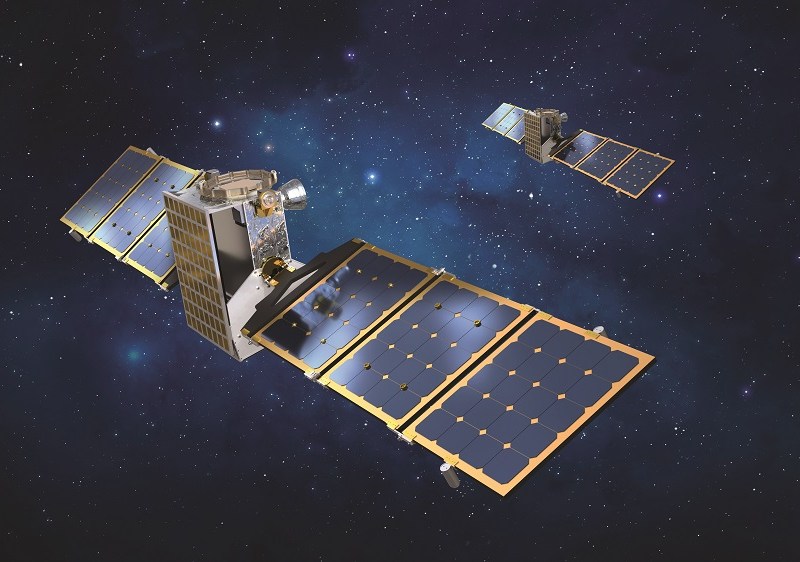 An illustration of a pair of rectangular satellites with rectangular solar arrays against a starry dark blue background.