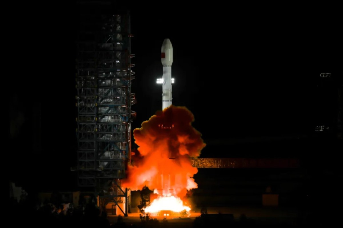 A Long March 3B rocket lifts off from the Xichang Satellite Launch Center at night, sending the Tianlian-2 (05) data relay satellite into orbit. Bright flames and smoke billow from the rocket’s base as it ascends past the illuminated launch tower.